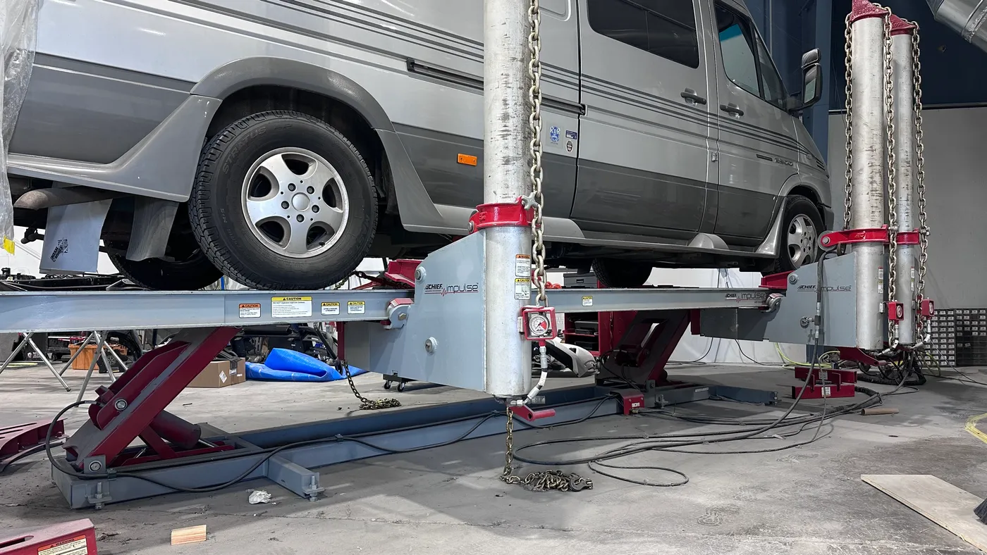 Commercial fleet van on the frame rack at Sky Auto Body in Medford, Oregon